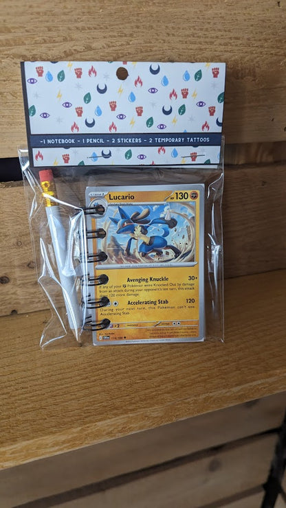 Pokémon card notebooks are packaged with a pencil, two random stickers, and two random temporary tattoos.